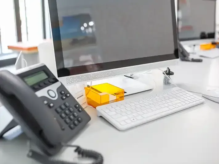 Telephone and computer on an office desk