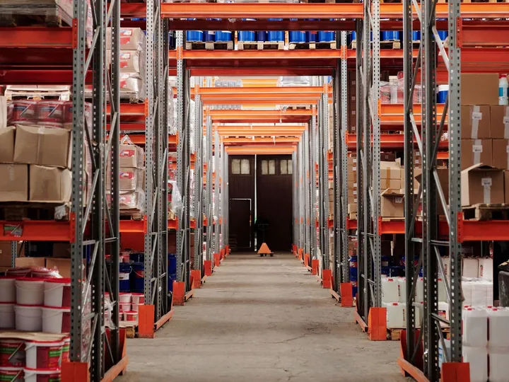 Pallets and goods on tall warehouse shelves